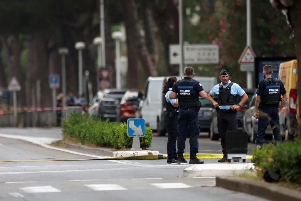 French police stand guard after cars were set on fire in front of the city's synagogue, in La Grande-Motte, France, August 24, 2024. 