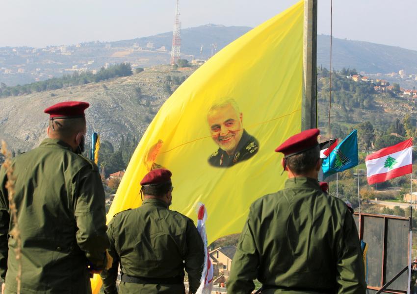 Lebanese Hezbollah forces with a banner showing Iranian general Qasem Soleimani. FILE